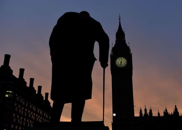 The sun rises behind the Palace of Westminster and the statue of Sir Winston Churchill, as one of the most closely-contested general elections for decades formally gets under way