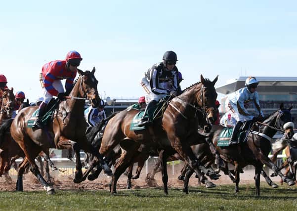 Balthazar King, left, Imperial Commander (centre) and Across The Bay, right, in action during the Grand National Day at the 2013 John Smith's Grand National Meeting at Aintree. Picture: David Davies/PA.
