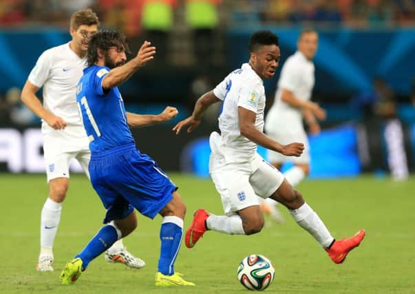 Raheem Sterling takes on Andrea Pirlo at the World Cup