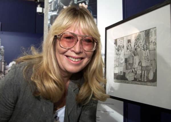 Cynthia Lennon with a series of her pen and ink drawings in 1999.