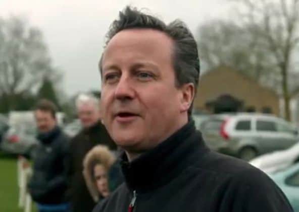 Screengrab taken from the first general election broadcast by the Conservative Party of party leader David Cameron watching children play football.
