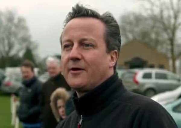 Screengrab taken from the first general election broadcast by the Conservative Party of party leader David Cameron watching children play football.