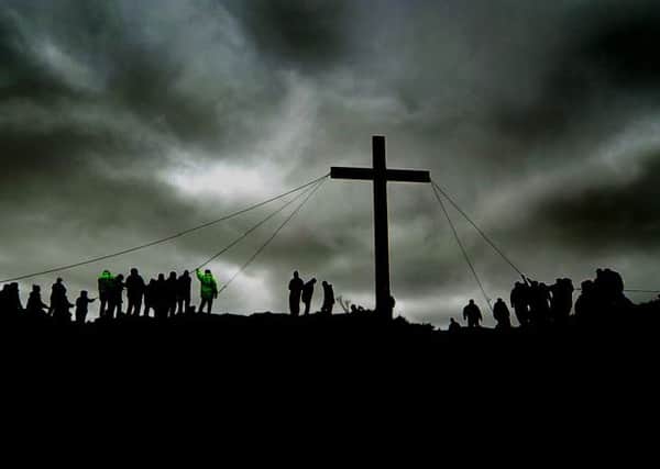 Spiritual renewal: The symbolic raising of the Cross on top of Otley Chevin shows that Christian values are still alive in the midst of a consumer-driven society. Picture: James Hardisty