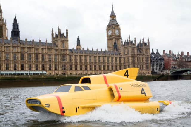 A 15ft replica of Thunderbird 4 by Tower Bridge as it travels down the River Thames in London to celebrate the launch of new television series Thunderbirds Are Go