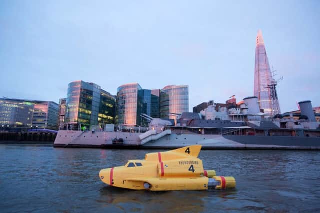 A 15ft replica of Thunderbird 4 by Tower Bridge as it travels down the River Thames in London to celebrate the launch of new television series Thunderbirds Are Go