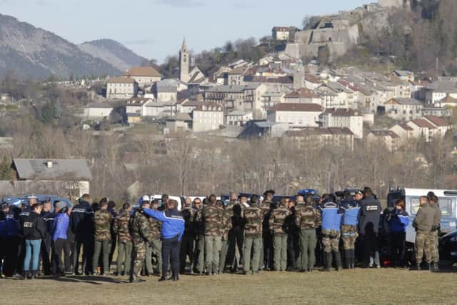 Mountain troops, police and gendarme officer  listen during a briefing before heading to the crash site