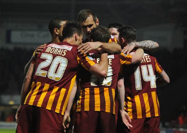 Billy Clarke is surrounded by jubilant Bradford City team-mates after his goals helped condemn Doncaster Rovers to defeat (Picture: Andrew Roe).
