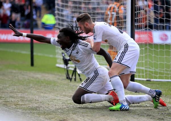 Swansea City's Bafetibis Gomis celebrates scoring his side's third goal against Hull.
