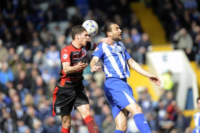 Sheffield Wednesday's Atdhe Nuhiu jumps with Huddersfield's Mark Hudson.