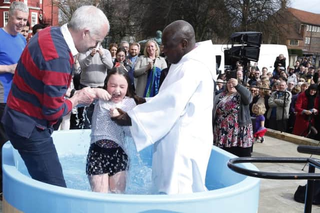 The Archbishop of York Dr John Sentamu (right) baptises Amelia Scarlet Lennox (centre) outside York Minster as part of the Easter celebrations. PRESS ASSOCIATION Photo. Picture date: Saturday April 4, 2015. Photo credit should read: Lynne Cameron/PA Wire