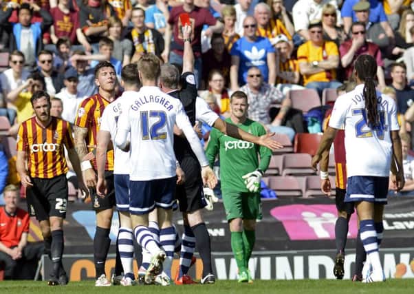 Referee Mark Heywood shows Christopher Routis a red card, reducing Bradford City to 10 men after just 14 minutes against Preston North End (Picture: Bruce Rollinson).