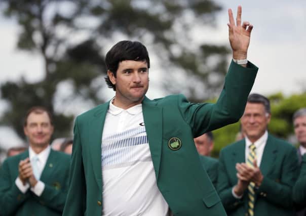 Bubba Watson waves after being presented with his green jacket following victory in the Masters last year, his second success in the tournament  (Picture: David J Phillip/AP).