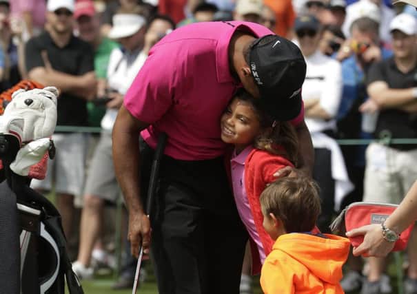 Tiger Woods greets his children Charlie, left, and Sam during a practice round at Augusta yesterday (Picture: Chris Carlson/AP).