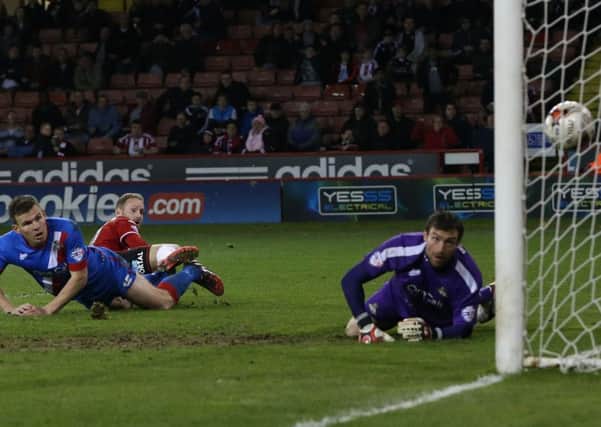 Matt Done, centre, watches as his effort beats Doncaster Rovers goalkeeper Stephen Bywater for the second of Sheffield Uniteds goals in a 3-2 win over the visitors at Bramall Lane (Picture: Martyn Harrison).