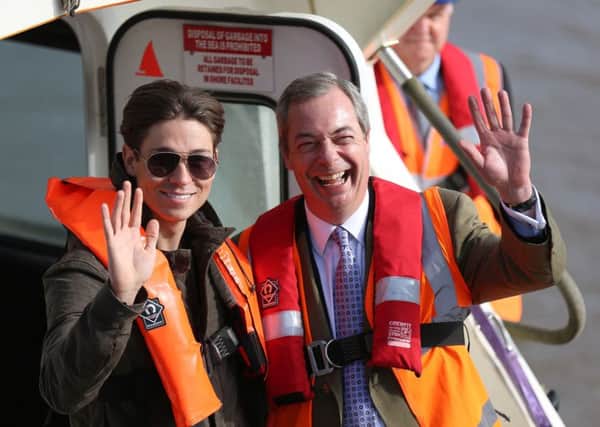 Nigel Farage and Joey Essex wave from the back of a boat. Nigel Farage visits Grimsby today April 8th. Garage has visited the marginal seat of Grimsby to support UKIP along with UKIP Parliamentary Candidate for Great Grimsby Victoria Ayling and Only Way is Essex star Joey Essex. 

Tom Maddick / Rossparry.co.uk