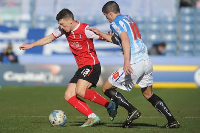 Rotherham United's Richard Smallwood, controls the ball infront of Huddersfield Town's Conor Coady.