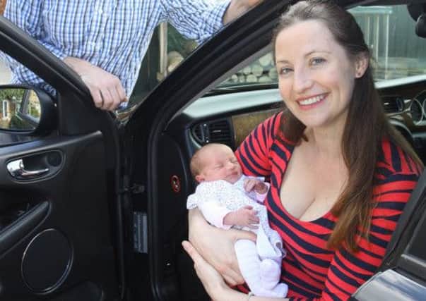 Ruth Whiffin and Matthew Howe with their daughter Eliza Rose who was born in their Jahuar car.