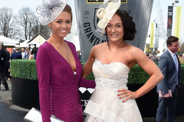 Female racegoers arrive at Aintree for Ladies Day of the Crabbies Grand National Festival at Aintree