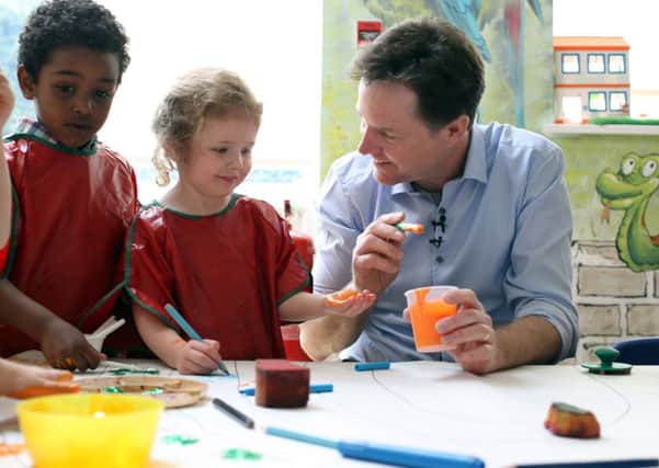 Nick Clegg paints with nursery school children yesterday