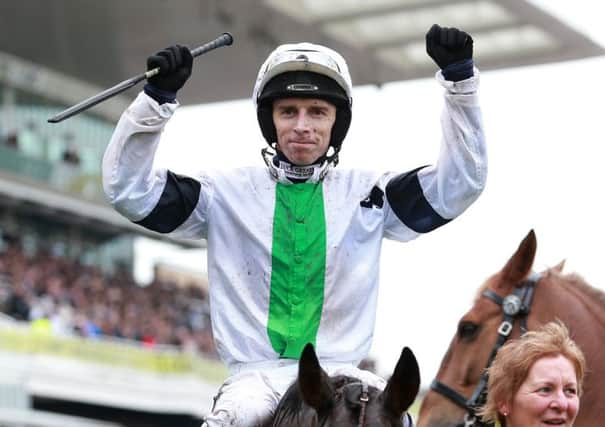 Leighton Aspell celebrates on Pineau De Re after winning The Crabbie's Grand National Steeple Chase during Grand National Day of the Crabbie's Grand National 2014 Festival at Aintree Racecourse, Liverpool.