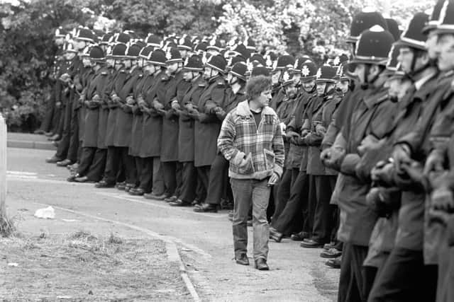 A picket walks in front of police lines at Orgreave