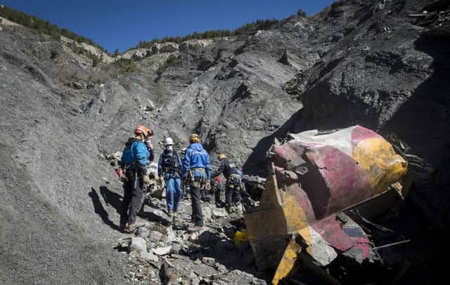French emergency rescue services work among debris of the Germanwings passenger jet at the crash site near Seyne-les-Alpes, France.