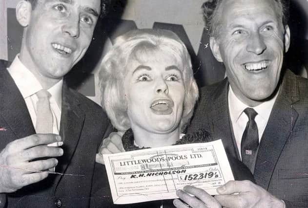 Viv Nicholson and husband Keith collect their Littlewoods pools cheque from Bruce Forsyth