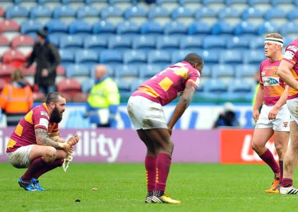 Huddersfield's players show their disappointment at the final whistle. Picture: John Rushworth