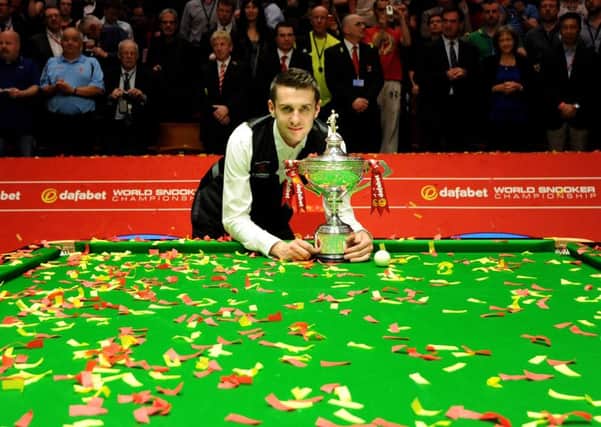Mark Selby celebrates after winning the final of the Dafabet World Snooker Championships.