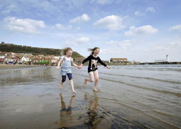 Bethany Shaw and Amy Harper from Inverness have fun on Scarborough's South Bay. 
Picture: Richard Ponter