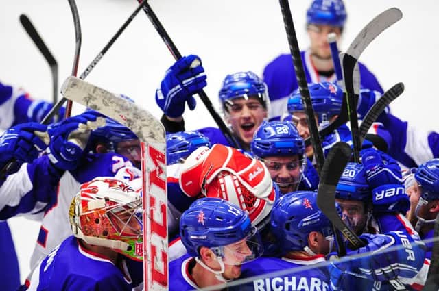 Great Britain's players mob Mark Richardson after his overtime winner against Croatia. 

Picture: Colin Lawson.