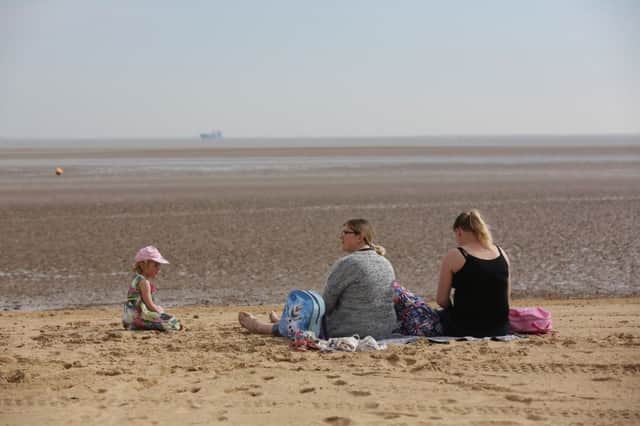 A family enjoying the early morning sun on Cleethorpes beach. Picture: Ross Parry Agency