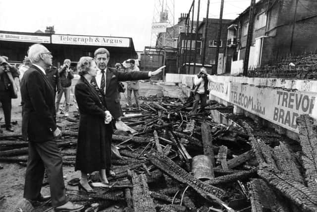 Margaret and Denis Thatcher are shown the fire damage by Stafford Heginbotham, chairman of Bradford City