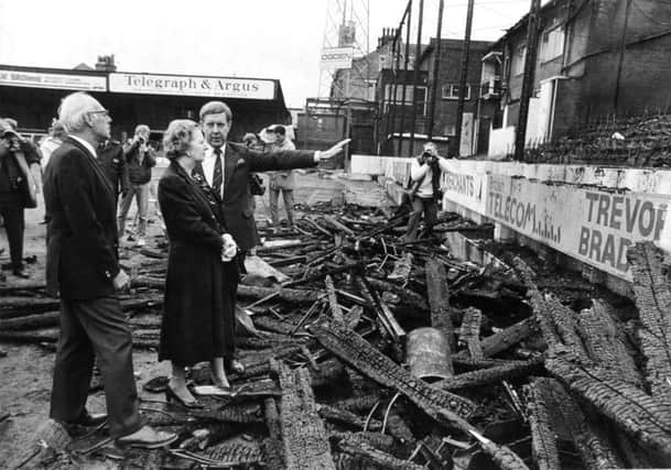 Margaret and Denis Thatcher are shown the fire damage by Stafford Heginbotham, chairman of Bradford City