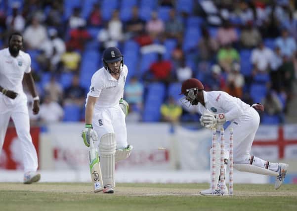 ON YOUR WAY: England's Ian Bell, center, is run out by West Indies' wicketkeeper Denesh Ramdin, right, Picture: AP/Ricardo Mazalan.