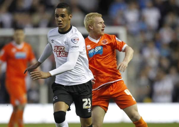 Blackpool's David Perkins battles with  Derby County's Thomas Ince