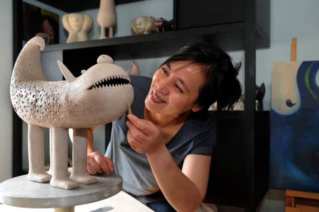 Artist Chiu-i Wu  working on one of  her clay creatures at her home in York