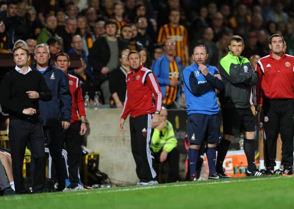 Phil Parkinson, far left, and Nigel Clough, far right, look on as Bradford City faced Sheffield United last October (Picture: Bruce Rollinson).