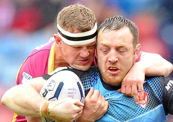 St Helens' James Roby and Huddersfield Giants' Luke Robinson in action.