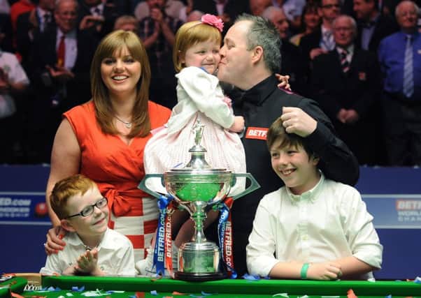 John Higgins is seen celebrating his fourth world title at the Crucible back in 2011 with his family (Picture: Anna Gowthorpe/PA Wire).