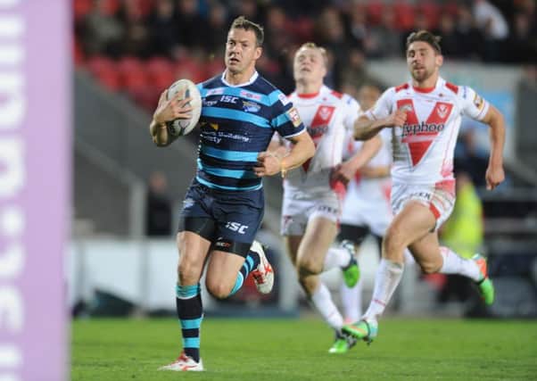 Danny McGuire runs in a  try.