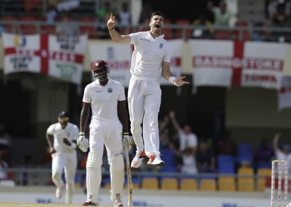 England's James Anderson celebrates taking the wicket of West Indies' Denesh Ramdin.