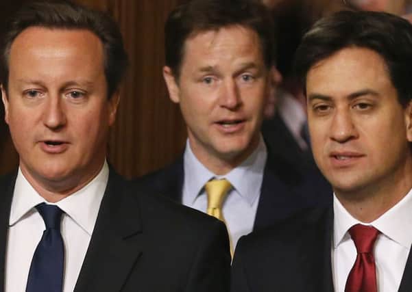 Prime Minister David Cameron (left), Deputy Prime Minister Nick Clegg (centre) and Leader of the Opposition Ed Miliband walk through the Members' Lobby in Parliament