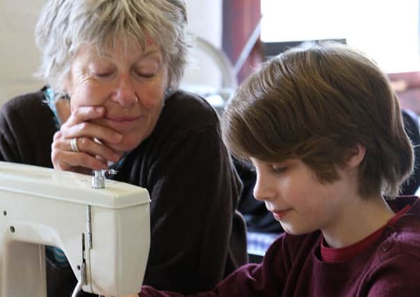 Helen Brewster starting up an after-school sewing club at Word of Mouth, Valley Road, Hebden Bridge with thirteen-year-old Abe Sugarman