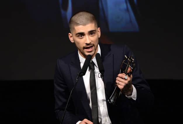Former One Direction band member Zayn Malik receives his Outstanding Achievement in Music award at the 2015 British Asian Awards