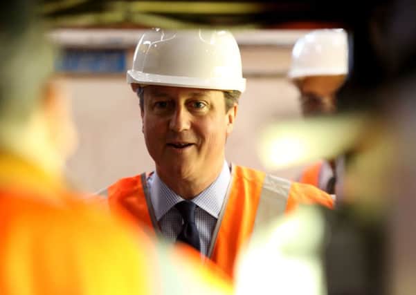 David Cameron visits a train depot yesterday