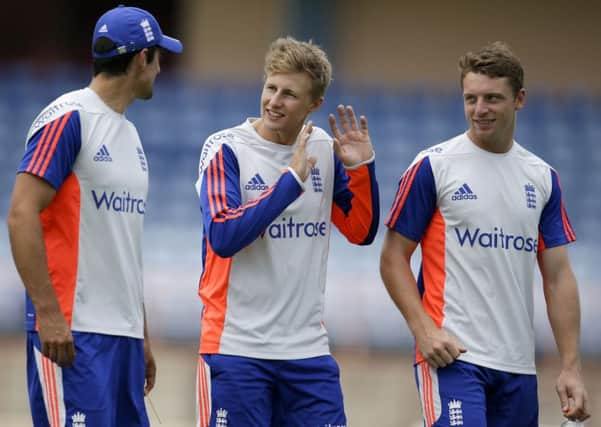 England captain Alastair Cook, left, and wicketkeeper Jos Buttler listen to Yorkshire's Joe Root, centre, at the National Stadium in St George's, Grenada yesterday (Picture: Ricardo Mazalan/AP).