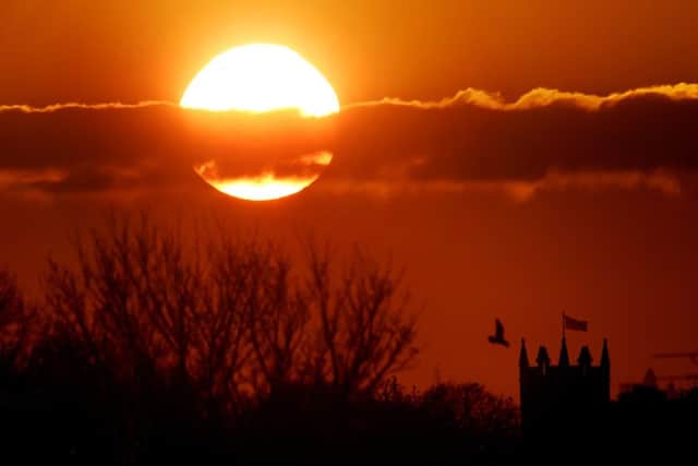 The sun balances next to St Albans Church in Earsdon, North Tyneside
