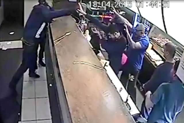 CCTV still from Imrans on the Wicker of a man who hurled chairs at the Sheffield takeaway's staff in sustained violent outburst
