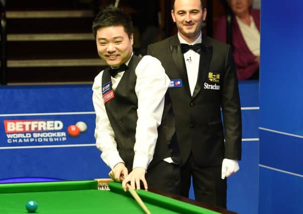 Ding Junhui reacts after missing a black during a possible 147 break against Mark Davis.
